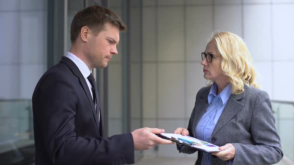 Angry Female Boss Shouting at Young Male Employee, Report Mistake, Work Failure