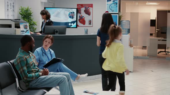 Mother with Child and Patients in Waiting Area Hospital Reception