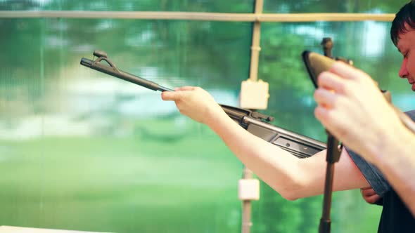 Closeup Young Guys Shoot at Shooting Range From Pneumatic Guns One of Them Broke a Gun