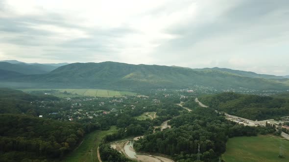 Aerial View of Sunset with Fog Above Forest and Mountains. Morning Foggy Smoke in Magic Rays Light