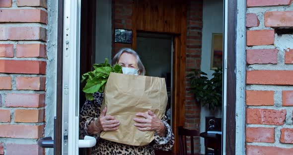 Senior Adult Receiving Food Delivery at Home