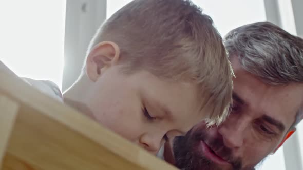 Boy Putting Screws into Furniture