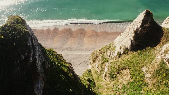 View From Above From the Top of a Cliff with Sharp Peaks to the Seashore
