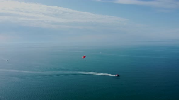 Parachute and motor boat inside the ocean