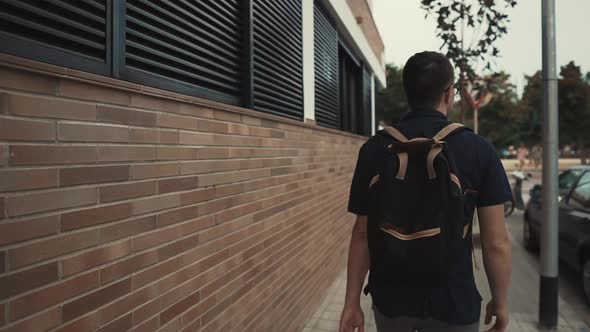 Man Walking Around in a City in Summer.