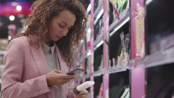 Woman Scanning QR Code On Beauty Product