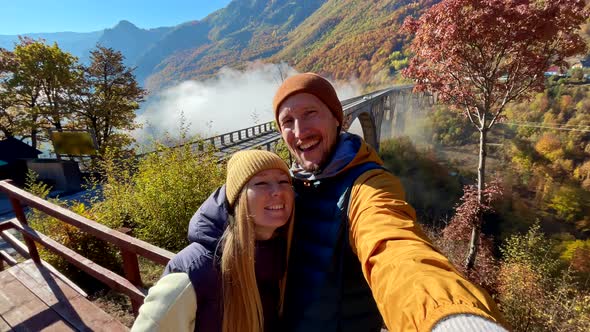 A Selfie Video of Two Tourists Woman and a Man Visiting the Magnificent Djurdjevica Bridge Over the