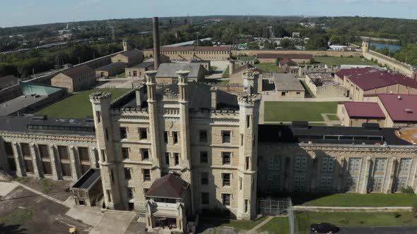 Aerial view of the old and abandoned Joliet prison or jail, a historic site. Drone flying backward t