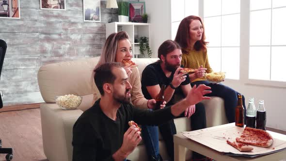 Group of Close Friends with Mouth Full of Pizza Celebrating Victory