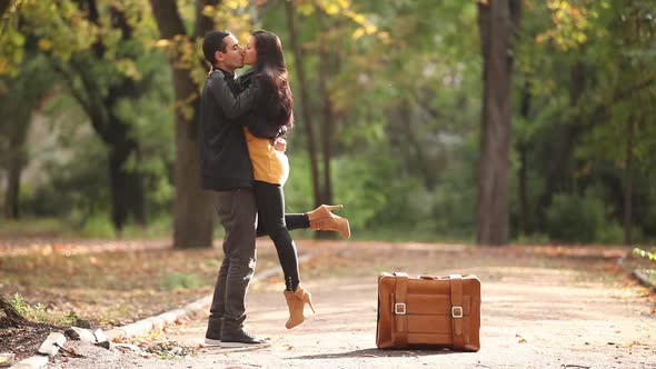 young coupe with suitcase in the autumn par