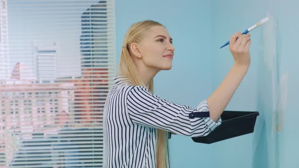 Close-up Shot of Woman Drawing a Flower on the Wall.