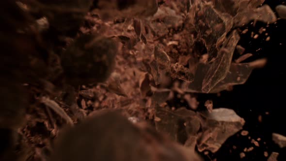 Super Slow Motion Detail Shot of Raw Chocolate Chunks Flying Towards Camera at 1000Fps