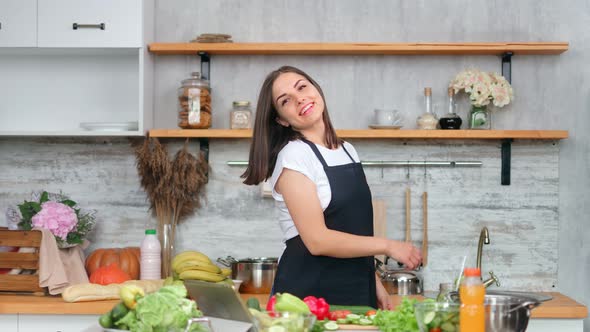 Smiling Female Dancing Listening Music Using Tablet During Cooking Meal at Kitchen Medium Shot