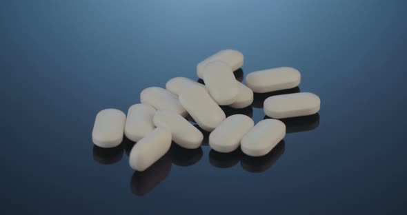 Prescription drugs - Capsules, pills, tablets on reflective background