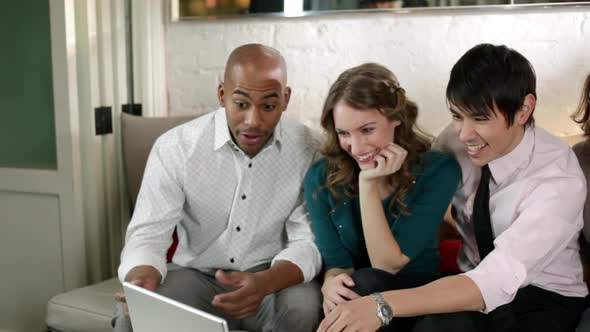 Young people looking at laptop