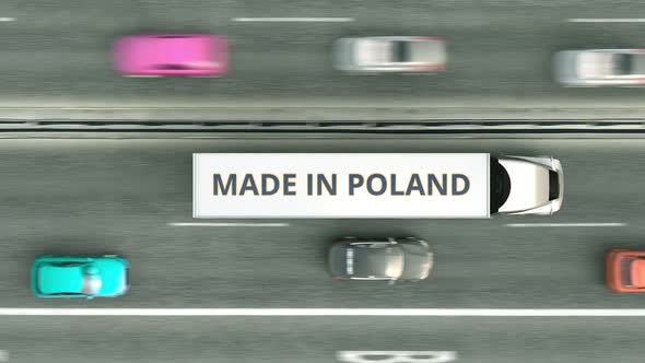 Trailer Trucks with MADE IN POLAND Text Driving Along the Road