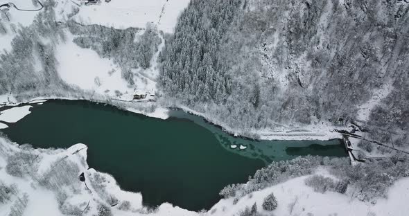 Drone Flight Arcing Over Forest And Green Klammsee Lake