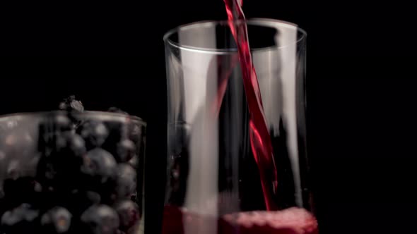 Pouring Natural Organic Blueberry Juice With Freshly Picked Blueberries in Glass