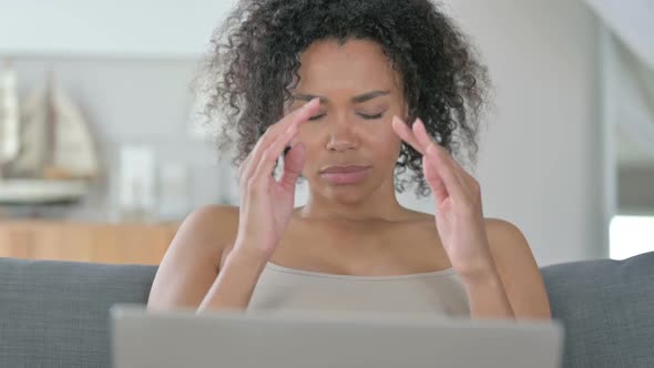 Stressed African Woman with Laptop Having Headache