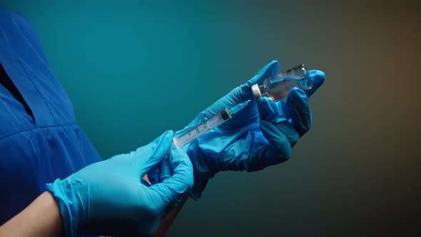Doctor Filling Syringe with Solution