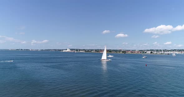 A sailboat catches the summer breeze near Newport Rhode Island in this 4k 60fps drone shot.