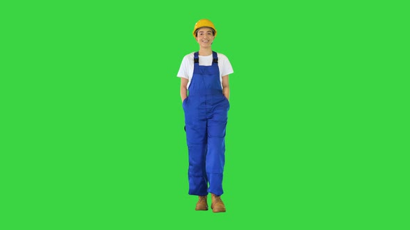 Young Woman in Yellow Hardhat Walking on a Green Screen Chroma Key