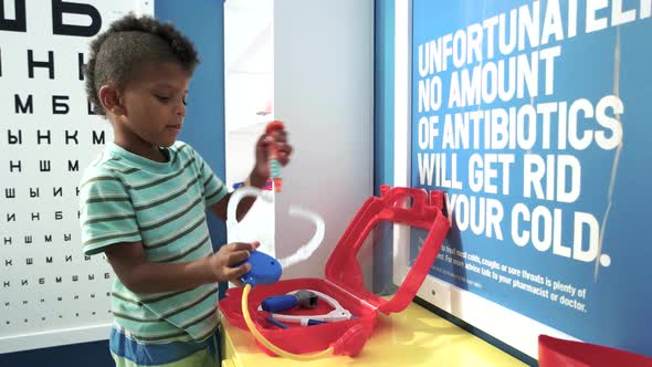 Cute Boy Doctor Playing in Medical Office