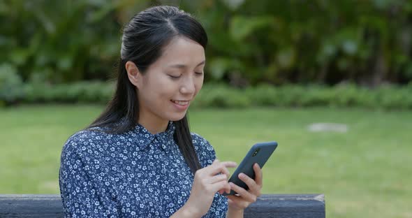 Woman use of mobile phone in the park