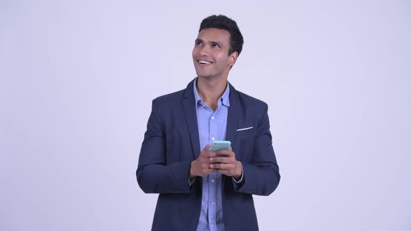 Happy Young Indian Businessman Using Phone