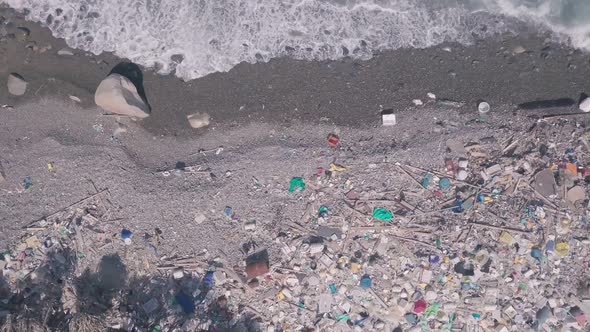 Environmental issues shown by beach covered in plastic and rubbish causing climate change in Hong Ko