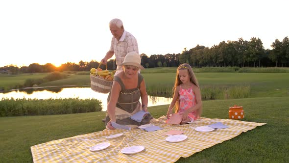 Elderly People and Child on Picnic.