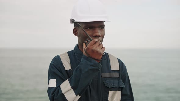 Marine Deck Officer or Chief Mate Speaks with VHF Walkietalkie Radio