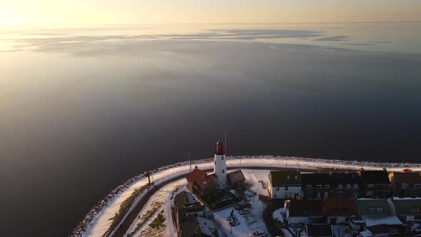 Urk Netherlands Lighthouse During Winter with Snow Covered Coastline Urk View at the Lighthouse