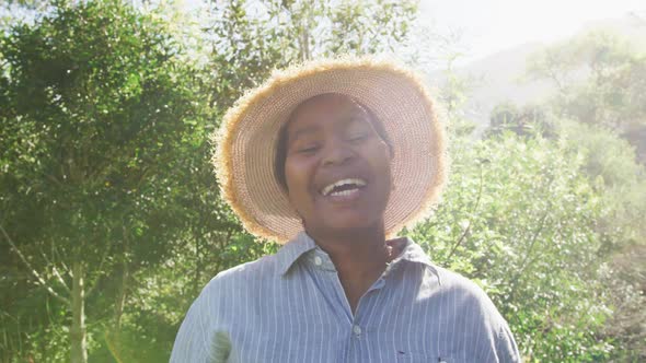 Happy african american senior woman looking at camera outdoors