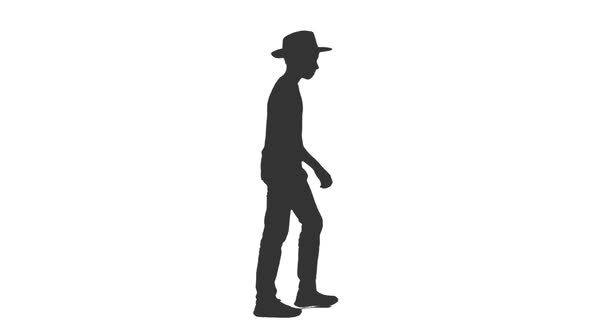 Silhouette of Stylish Teen Boy Walking in Hat alt