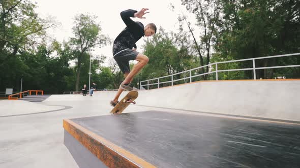 Skateboarder in Skate Park Doing Tricks Slow Motion