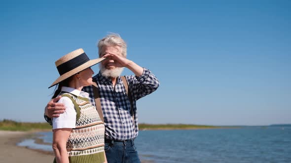 Happy Old Couple Hugging While Standing By the Sea or Ocean