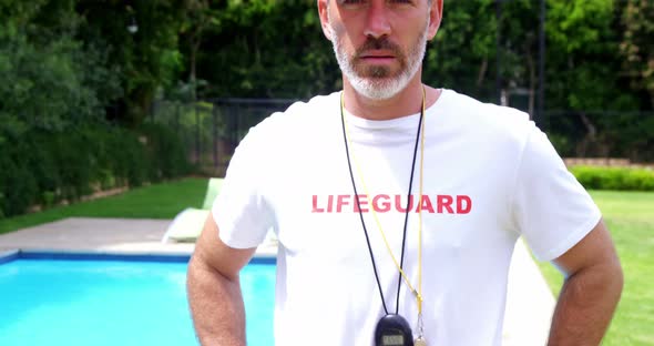 Lifeguard standing at pool side