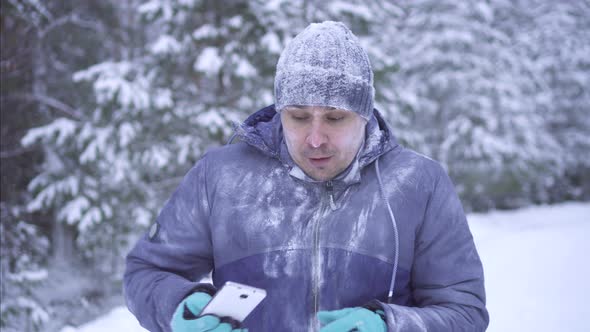 Frozen Man in Cold Winter Using Telephone