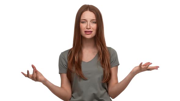 Portrait of Perplexed Woman 20s in Casual Tshirt Gesturing in Furious Manner and Asking Question