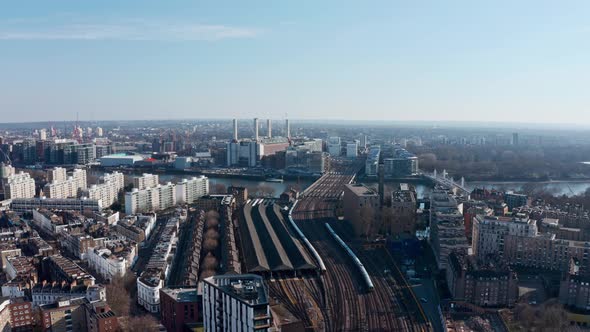 Circling drone shot over London railway tracks Battersea Power station Grosvenor bridge