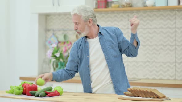 Happy Old Man Dancing in Kitchen