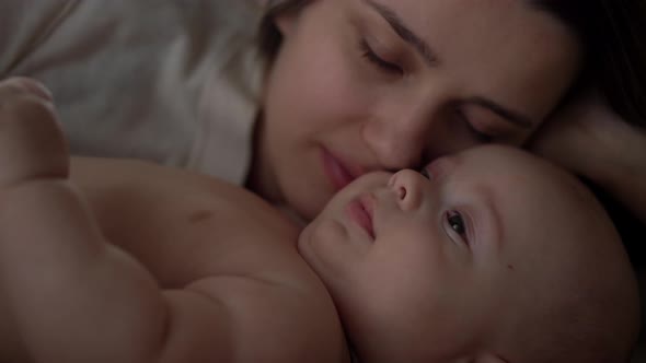 Newborn Baby With Young Mom Look Into Each Other Eye