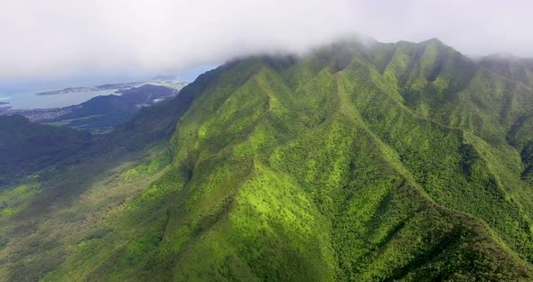 Clouds cover the top of a mountain in Hawaii in an aerial shot