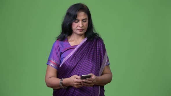 Mature Happy Beautiful Indian Woman Using Phone