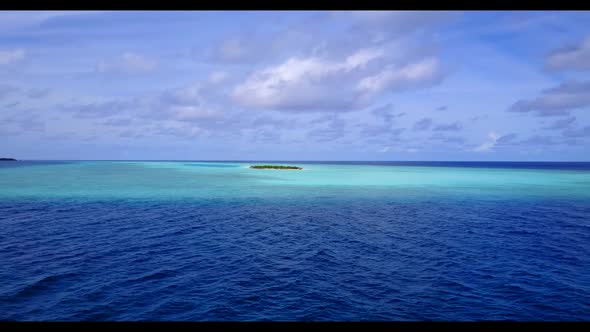 Aerial flying over seascape of idyllic bay beach adventure by clear lagoon with bright sand backgrou