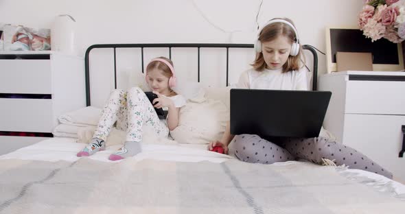 Cute Kids Use Laptops and Headphone for Education Online Study