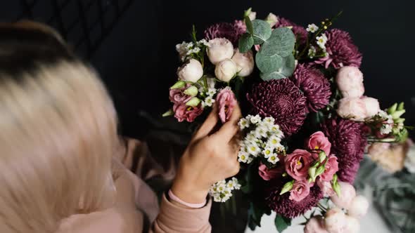 A Florist Makes Up a Large Bouquet in a Flower Shop Closeup