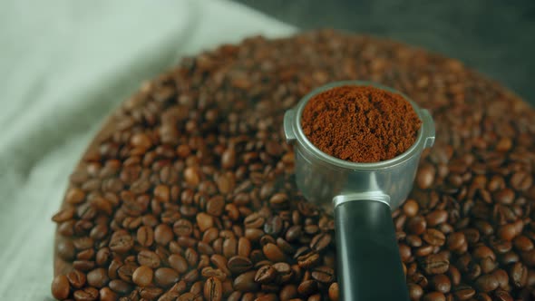 Ground Coffee in Portafilter on Wooden Board with Coffee Beans and Dissipating Steam