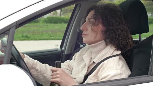 Woman is Drinking Wine While Sitting in Her Car